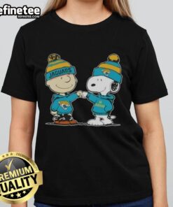 Charlie Brown and Snoopy fist bump in Jacksonville Jaguars football ladies tee featuring Nice Peanuts design.