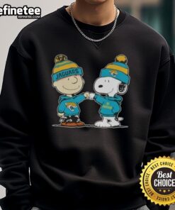 Alt Text: Charlie Brown and Snoopy fist bump on a Jacksonville Jaguars football sweatshirt featuring Nice Peanuts design.