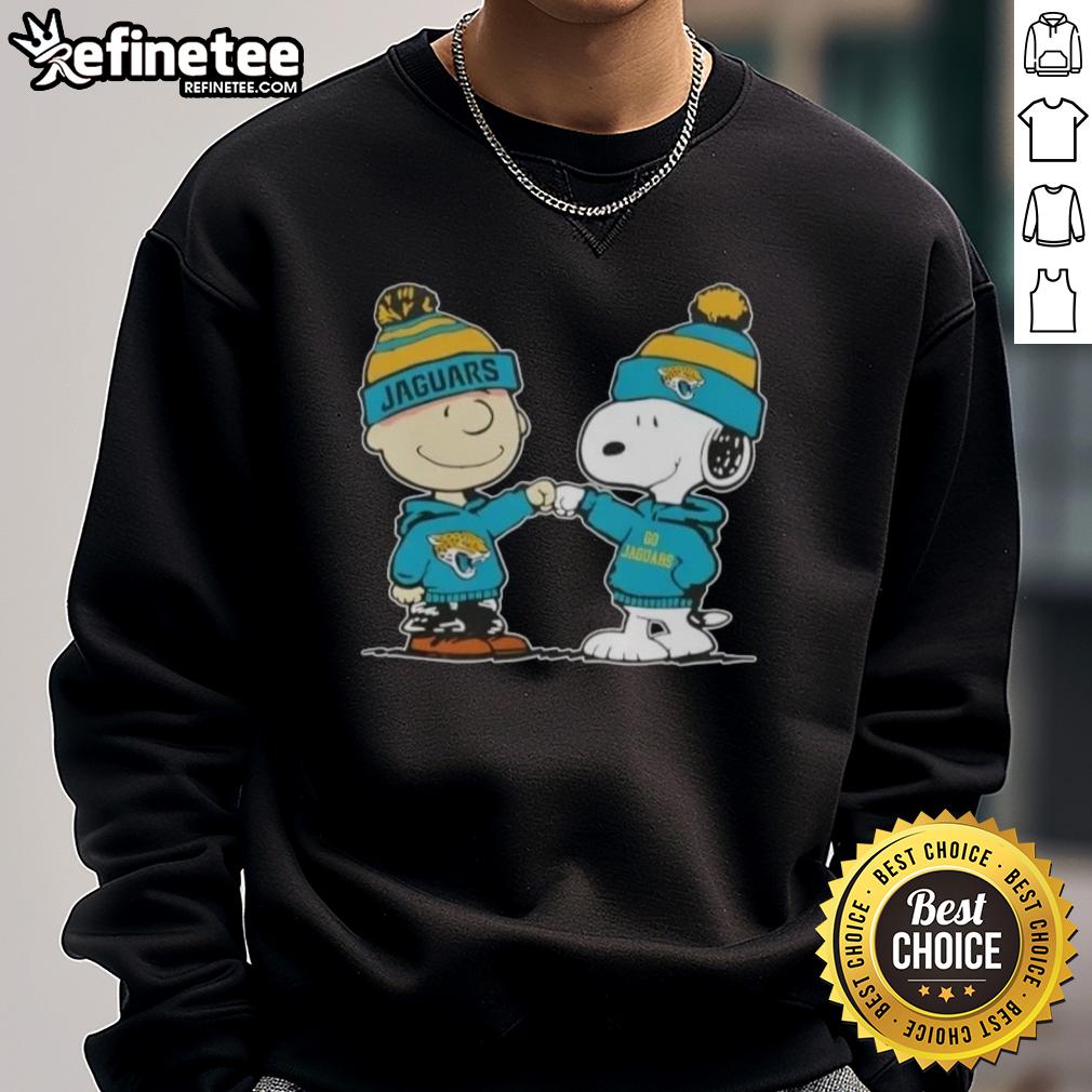 nice-peanuts-charlie-brown-fist-bump-snoopy-x-jacksonville-jaguars-football-sweatshirt Alt Text: Charlie Brown and Snoopy fist bump on a Jacksonville Jaguars football sweatshirt featuring Nice Peanuts design.