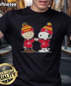 Nice Peanuts Charlie Brown fist bump with Snoopy on Kansas City Chiefs football t-shirt design for fans.