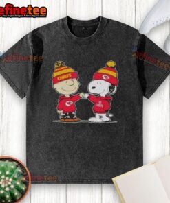 Charlie Brown and Snoopy fist bump in Kansas City Chiefs washed t-shirt design, perfect for football fans.