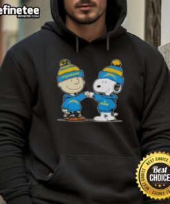 Charlie Brown and Snoopy fist bump in Los Angeles Chargers football hoodie, showcasing Nice Peanuts design.