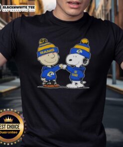 Charlie Brown and Snoopy fist bump on a Los Angeles Rams football T-shirt, perfect for Peanuts fans and sports lovers.