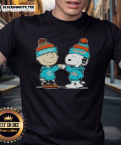 Nice Peanuts Charlie Brown fist bump with Snoopy on Miami Dolphins football T-shirt, perfect for fans and collectors.