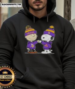 Charlie Brown and Snoopy fist bump in a Minnesota Vikings football hoodie, showcasing Nice Peanuts-themed apparel.