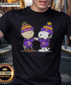 Charlie Brown and Snoopy fist bump on a Minnesota Vikings football T-shirt, celebrating teamwork and fandom.