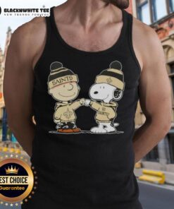 Charlie Brown fist bumping Snoopy in a New Orleans Saints football tank top featuring Nice Peanuts design.