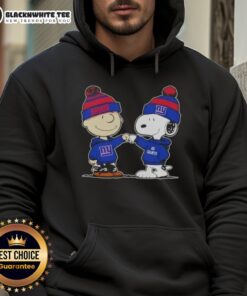 Charlie Brown and Snoopy fist bump in a New York Giants football hoodie, celebrating friendship and sports spirit.