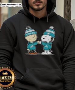 Charlie Brown and Snoopy give a fist bump in a Philadelphia Eagles hoodie, showcasing Nice Peanuts football spirit.