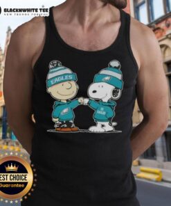 Charlie Brown fist bumping Snoopy in Philadelphia Eagles tank top featuring Nice Peanuts design.