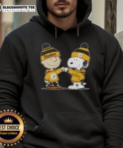 Charlie Brown and Snoopy fist bump in a Pittsburgh Steelers hoodie, showcasing their love for football and friendship.