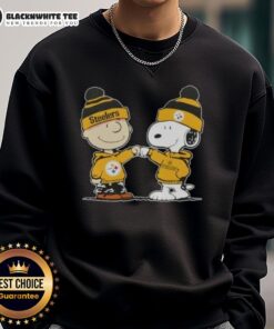 Charlie Brown and Snoopy fist bump in a Pittsburgh Steelers sweatshirt, celebrating friendship and football spirit.
