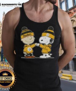Charlie Brown and Snoopy fist bump in Pittsburgh Steelers tank top, celebrating friendship and football spirit.