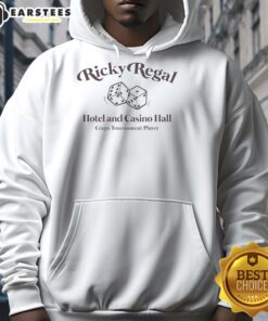 Player wearing Nice Ricky Regal Hotel and Casino hoodie at a craps tournament, showcasing excitement and competition.