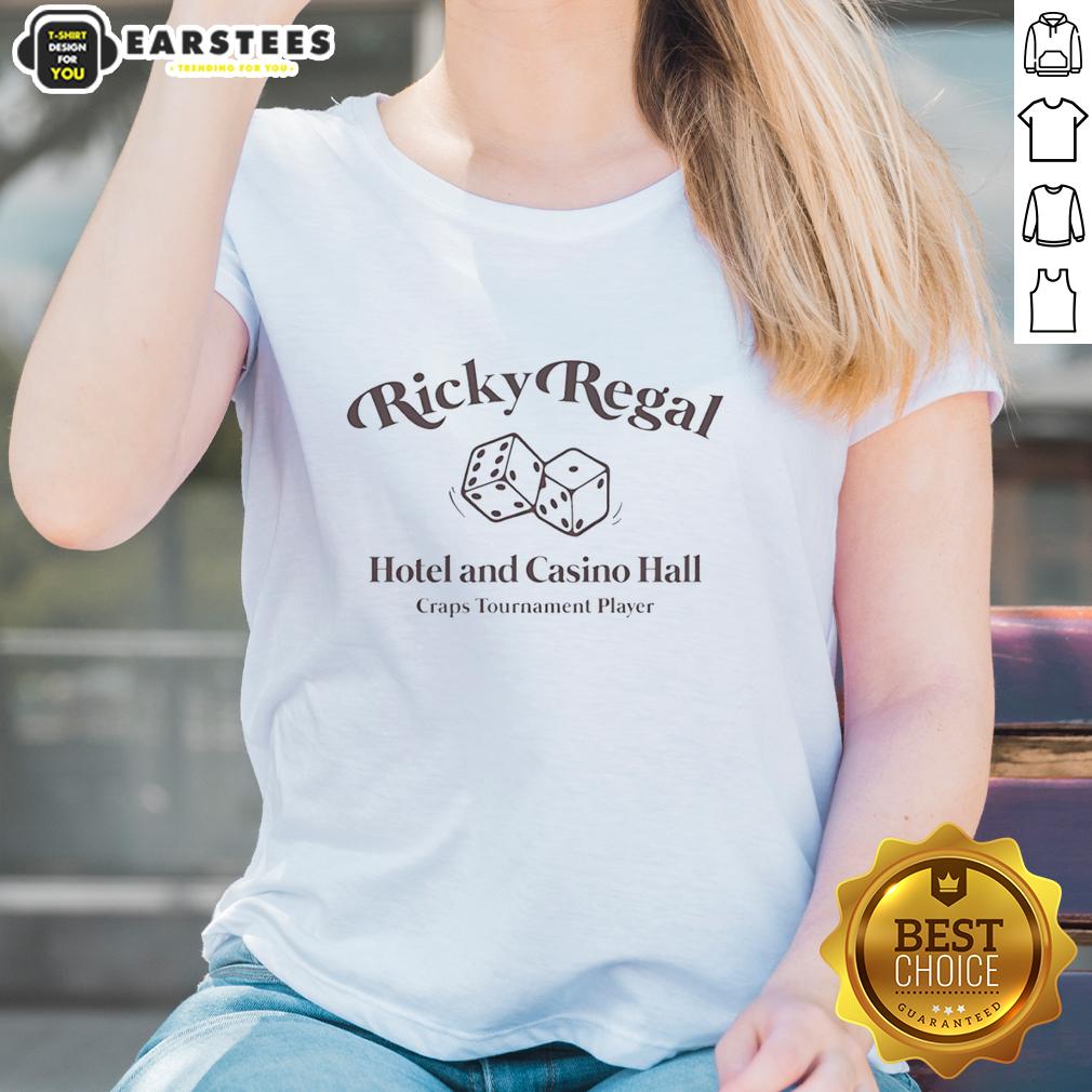 nice-ricky-regal-hotel-and-casino-hall-craps-tournament-player-ladies-tee Female player at Nice Ricky Regal Hotel and Casino hall during a craps tournament, showcasing excitement and strategy.