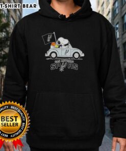 Snoopy driving a car in a San Antonio Spurs basketball hoodie, showcasing fun sports-themed apparel.