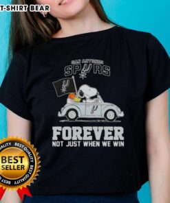 Alt Text: Snoopy driving a car in a San Antonio Spurs tee, celebrating team spirit with 'Forever, Not Just When We Win' slogan.