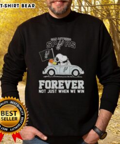 Alt Text: Snoopy driving a car in a San Antonio Spurs sweatshirt, showcasing team spirit with 'Forever, Not Just When We Win' slogan.