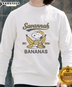 Alt Text: Snoopy lying on a banana wearing a Savannah Bananas outfit, featuring the Est. 2016 sweatshirt design.