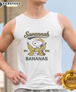 Alt Text: Snoopy lying on a banana, wearing a Savannah Bananas outfit, with 'Est. 2016' tank top, showcasing a fun summer vibe.