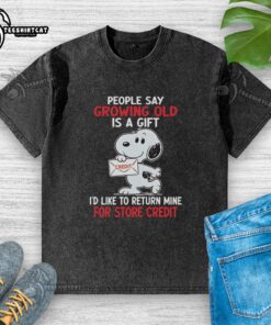 Funny Snoopy t-shirt saying 'Growing old is a gift I'd like to return for store credit' on a washed fabric.
