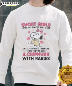 Cute girl in a pink bow sweatshirt featuring Snoopy, showcasing a sweet and stylish look.