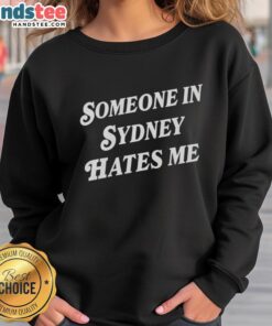 Cozy 'Someone In Sydney Hates Me' sweatshirt displayed against a vibrant urban backdrop, perfect for casual style.