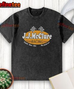 Nice The Cannonball Run J.J. McClure Racing Land Sea Air We Deliver washed t-shirt displayed on a wooden background.
