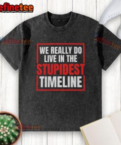 Vintage washed t-shirt featuring the phrase 'We Really Do Live In The Stupidest Timeline' for casual wear enthusiasts.