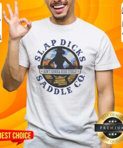 Alt Text: Official Ain't Gonna Ride Itself Slap Dicks Saddle Co Logo T-Shirt featuring a bold logo design and vibrant colors.