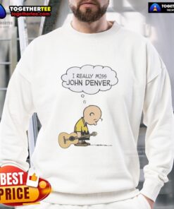 Charlie Brown holding a guitar in 'I Really Miss John Denver' sweatshirt, showcasing a nostalgic vibe and musical tribute.