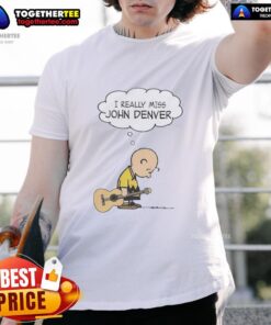 Alt Text: Official Charlie Brown holding a guitar wearing I Really Miss John Denver T-shirt, perfect for fans of both icons.