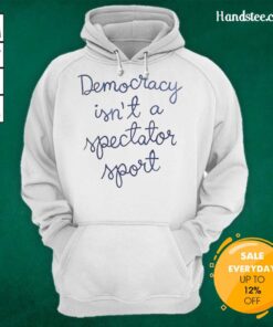 Official Democracy Is Not A Spectator Sport hoodie worn by Nicolle Wallace, promoting civic engagement and participation.