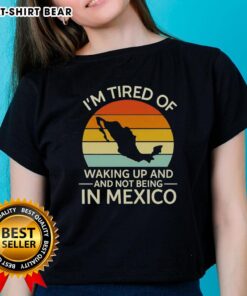 Retro ladies tee with 'I'm Tired of Waking Up and Not Being in Mexico' graphic, featuring a sunset design.