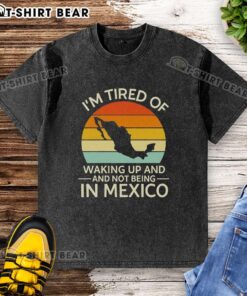 Retro washed t-shirt featuring 'I'm Tired of Waking Up and Not Being in Mexico' design, perfect for sunset lovers.