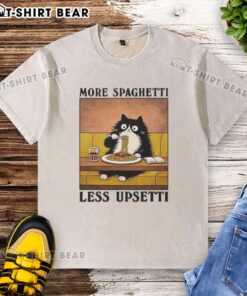 Alt Text: Black cat enjoying spaghetti on a washed t-shirt featuring More Spaghetti, Less Upsetti design.