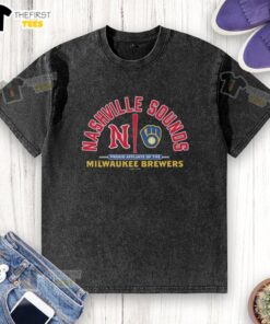 Official Nashville Sounds Proud Affiliate of the Milwaukee Brewers washed t-shirt displayed on a hanger.