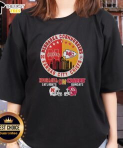 Alt Text: Nebraska Cornhuskers and Kansas City Chiefs helmet logo mashup on a ladies tee, perfect for football fans.