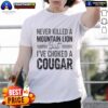 Alt Text: Official Never Killed A Mountain Lion But I've Choked A Cougar T-Shirt featuring bold graphic design and humor.