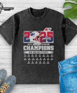 Alt Text: Official New England Patriots 2025 AFC East Division Champions helmet graphic on a washed t-shirt, showcasing team pride.