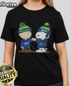 Official Peanuts Charlie Brown fist bump with Snoopy on Seattle Seahawks football ladies tee design.