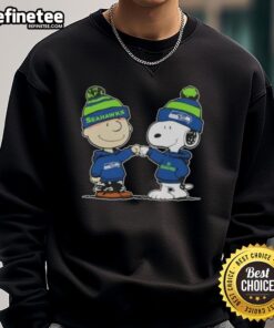 Official Peanuts Charlie Brown fist bump with Snoopy on Seattle Seahawks football sweatshirt, perfect for fans.