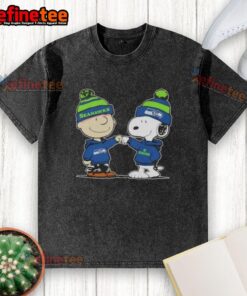 Alt Text: Charlie Brown and Snoopy fist bump in a Seattle Seahawks washed t-shirt, perfect for football fans and Peanuts lovers.