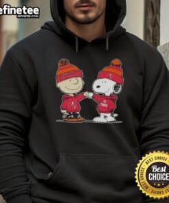 Official Peanuts Charlie Brown fist bumping Snoopy in Tampa Bay Buccaneers football hoodie, perfect for fans.