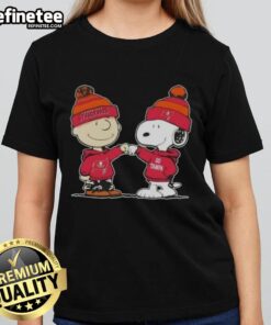 Official Peanuts Charlie Brown fist bump with Snoopy on a Tampa Bay Buccaneers football ladies tee design.