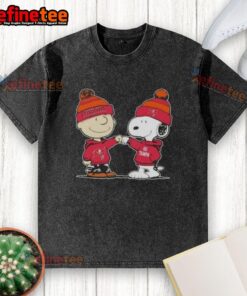 Official Peanuts Charlie Brown fist bump with Snoopy in Tampa Bay Buccaneers football washed t-shirt design.