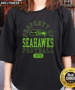 Alt Text: Official Property of Seattle Seahawks Football Since 1976 Ladies Tee in navy blue, featuring team logo and stylish design.