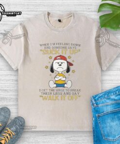 Official Snoopy t-shirt featuring a humorous quote about feeling down and breaking legs, perfect for Peanuts fans.