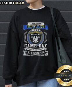 Alt Text: Stylish sweatshirt with 'I May Live In Nevada But On Game Day My Heart Belongs To Las Vegas Raiders' design.
