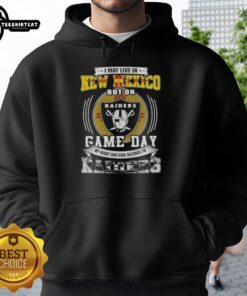 Man wearing an 'I May Live In New Mexico But My Heart Belongs To Las Vegas Raiders' hoodie, showcasing team pride.